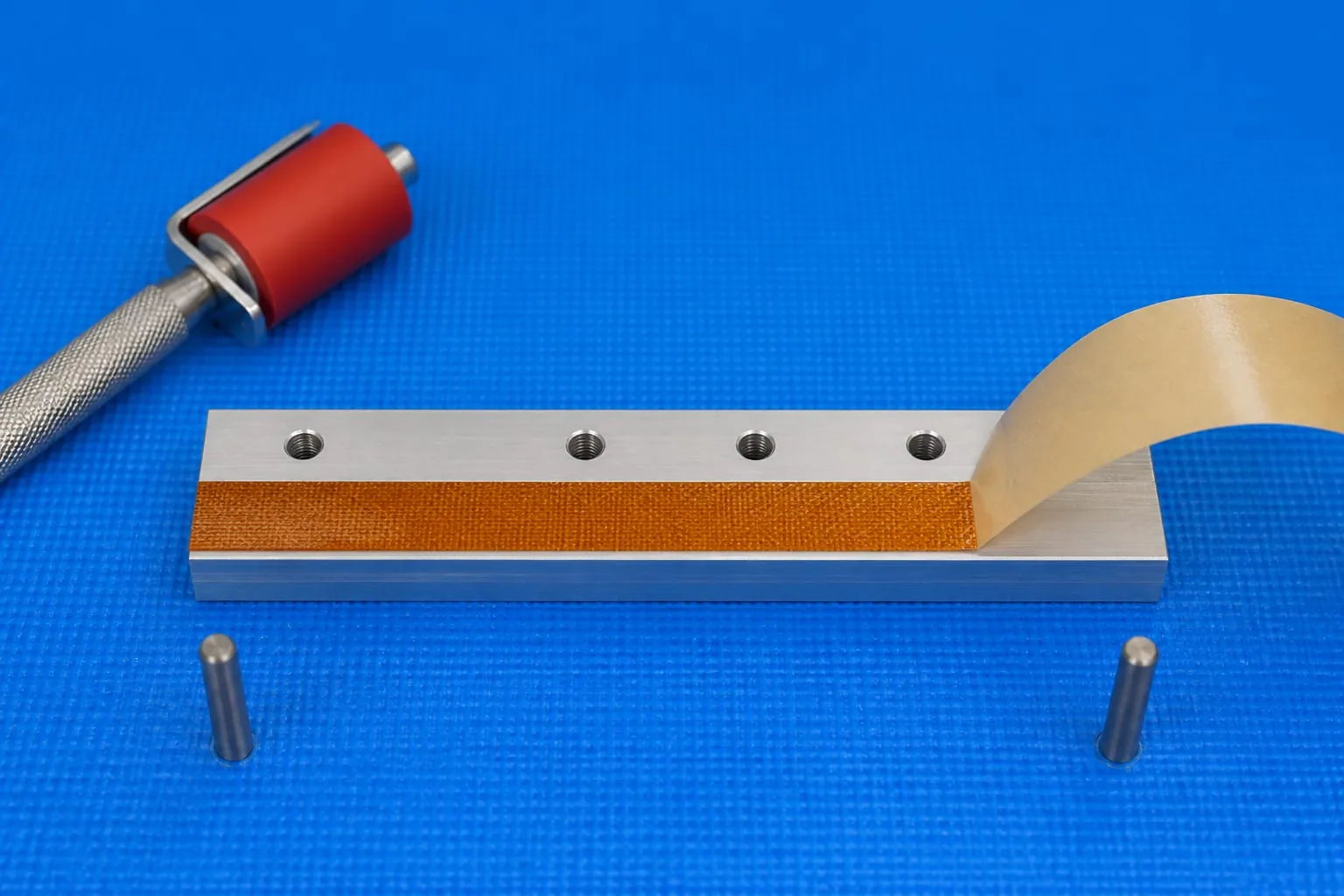 Woven PTFE heat-seal tape aligned on an aluminium seal bar